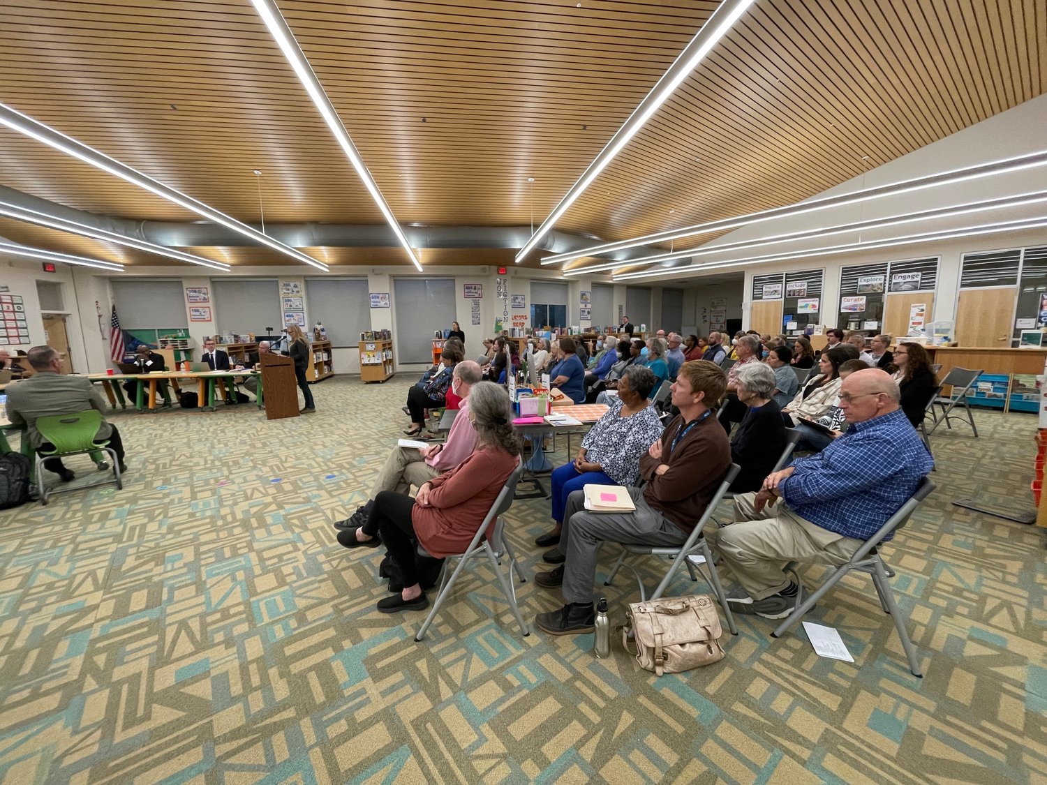 Dozens of parents and community members gathered in Chatham Grove Elementary's media center on Monday night to express support for the current school board.