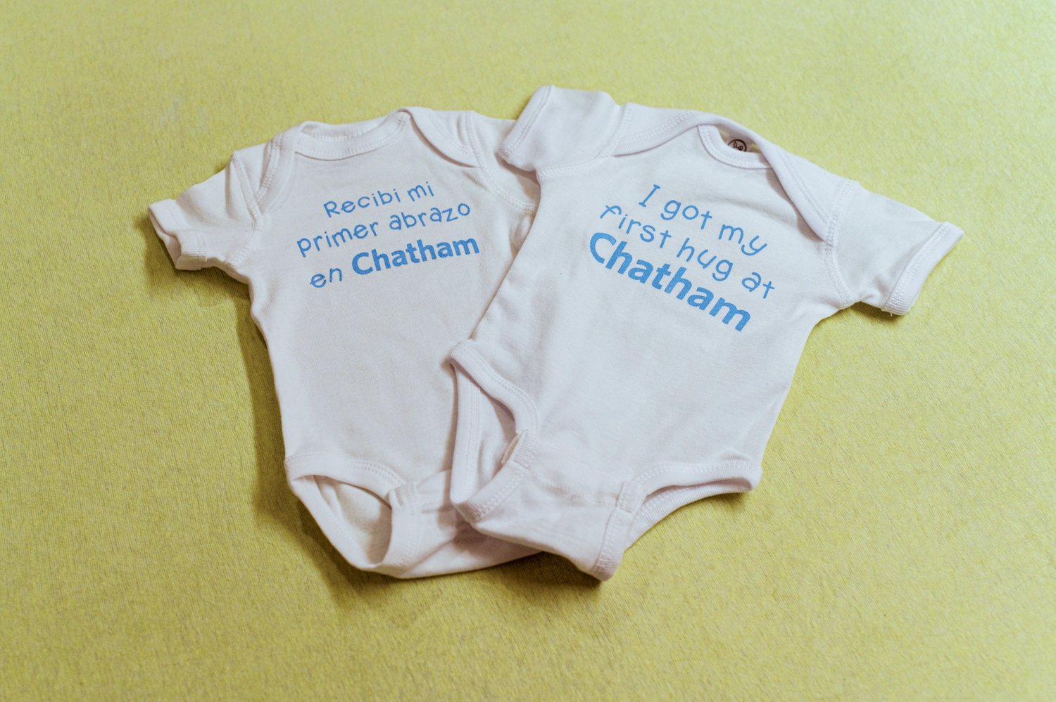 Before leaving the UNC Chatham Hospital Maternal Care Center, every newborn gets a onesie that says 'I got my first hug at Chatham' in English or Spanish.