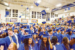 Graduation caps fly in the air in the Jordan-Matthews gym Saturday morning as the former students celebrate the end of an era. Principal Tripp Crayton reminded them, 'Once a Jet, always a Jet!'