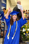 Kaitlyn Rose Bellas, a new graduate of Jordan-Matthews High School in Siler City, waves to her friends and family after receiving her diploma Saturday morning.